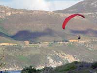 Para Glider crossing Chapman's Peak Road to land on Hout Bay beach