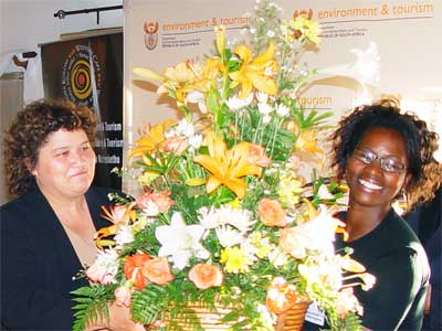 MEC Ms Lynne Brown, left, receiving a Bouquet from Noxolo Ntenetya